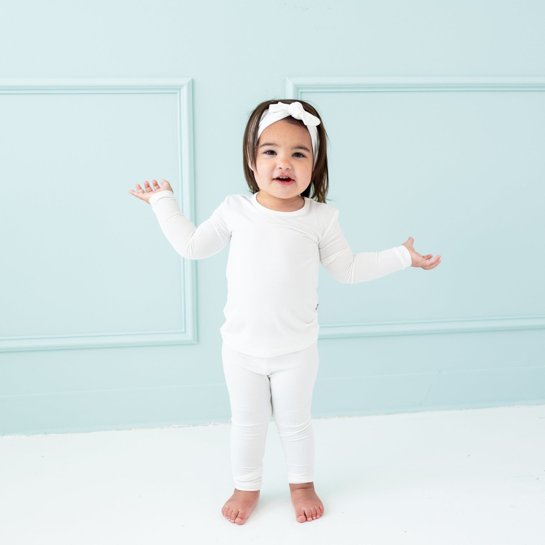 Toddler wearing Long Sleeve Pajamas in Cloud  and matching bow headband