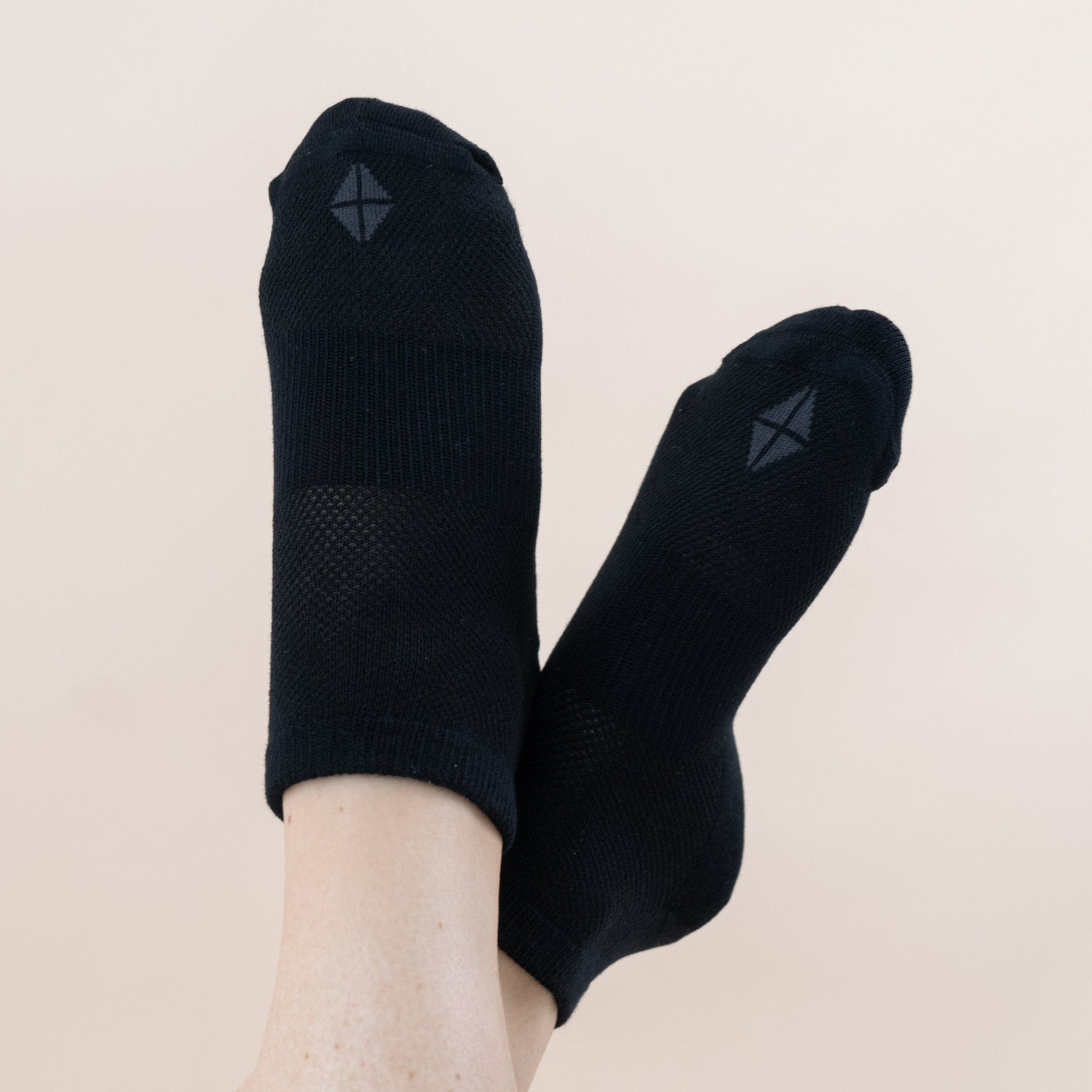 Woman wearing pair of Kyte Baby Women's Ankle Socks in Midnight