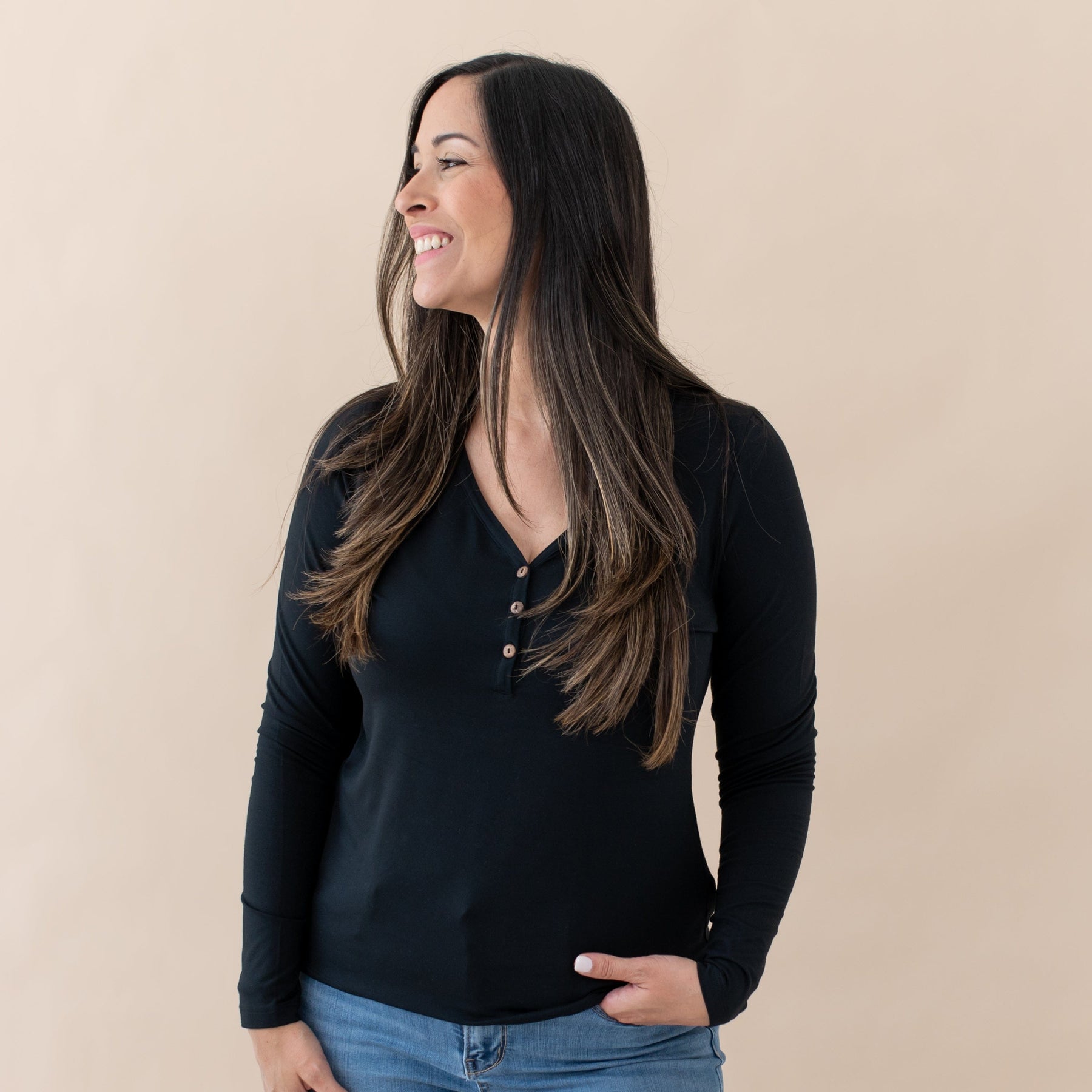 Woman wearing Kyte Baby Women's Breathable Long Sleeve Henley Tee in Midnight