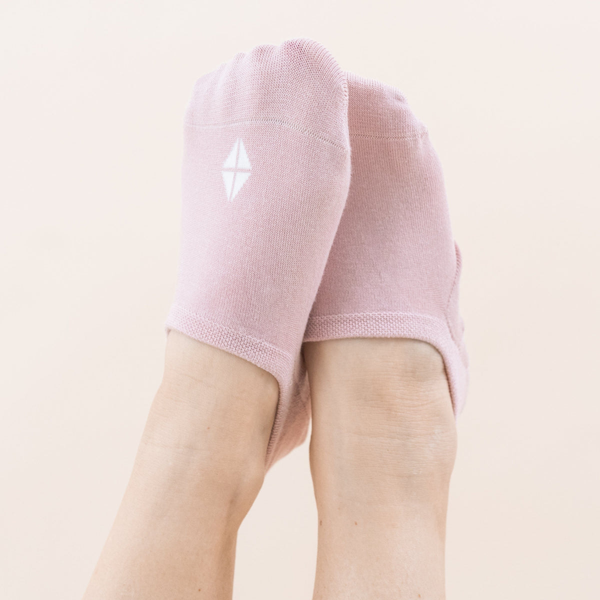Model wearing a Pair of Kyte Baby Bamboo Women's No Show Socks in Neutral Blush