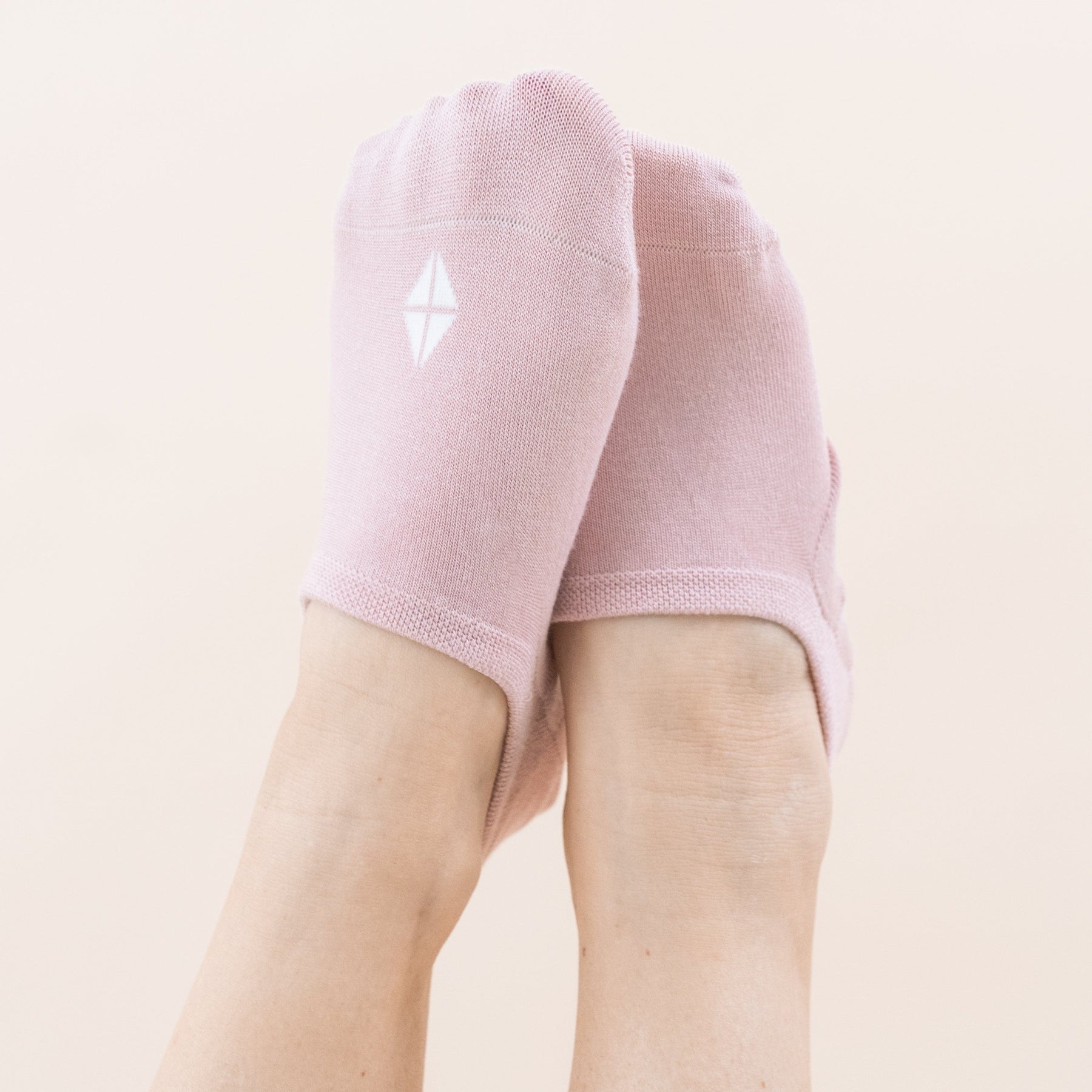 Model wearing a Pair of Kyte Baby Bamboo Women's No Show Socks in Neutral Blush