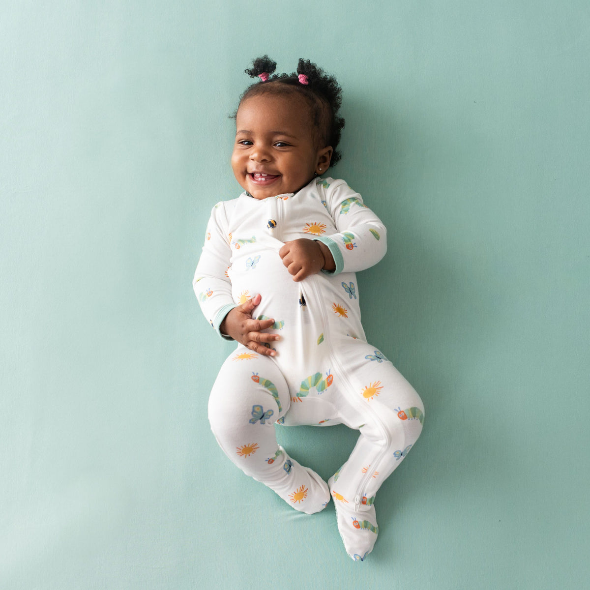 Smiling toddler wearing the Zippered Footie in The Very Hungry Caterpillar™ and Friends