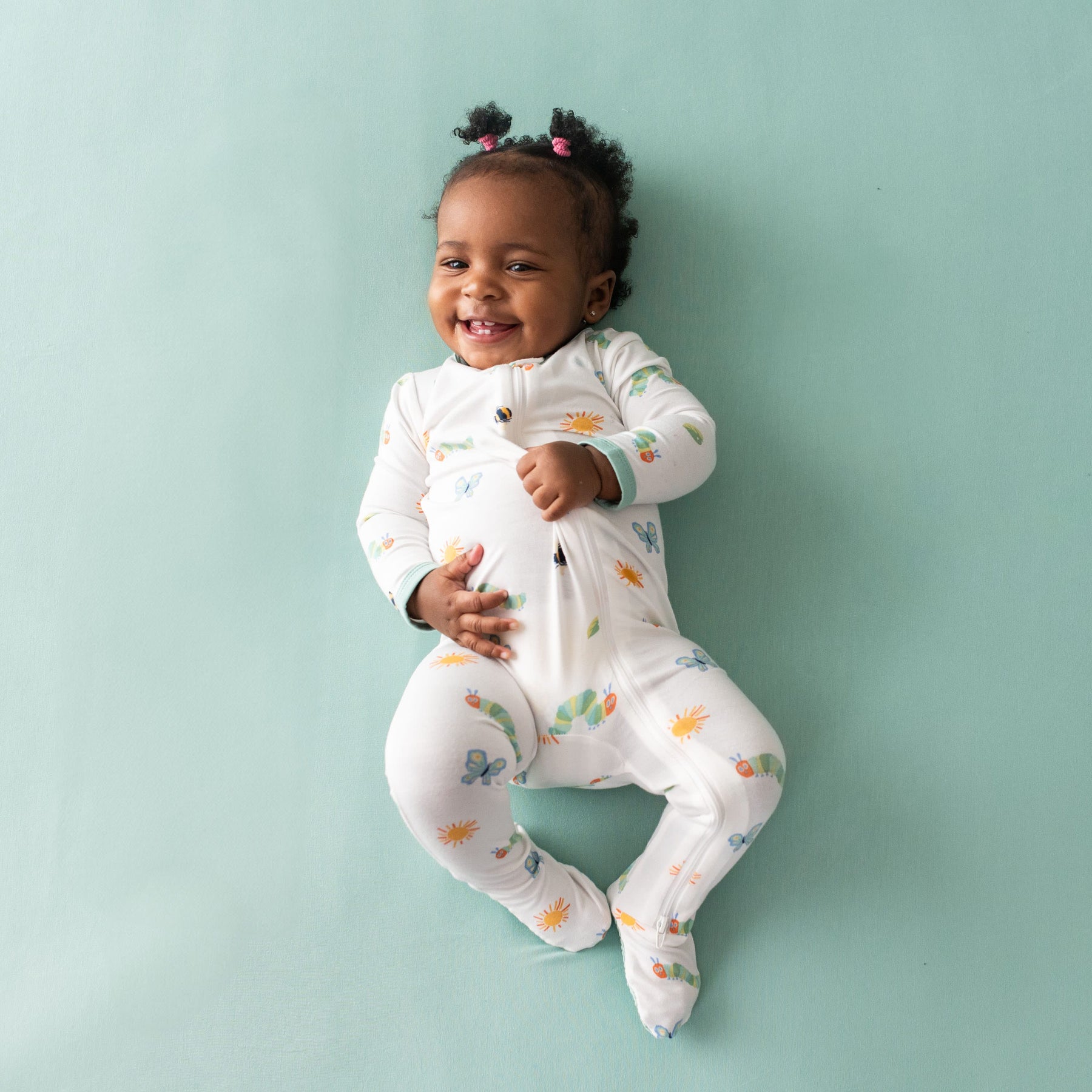 Smiling toddler wearing the Zippered Footie in The Very Hungry Caterpillar™ and Friends