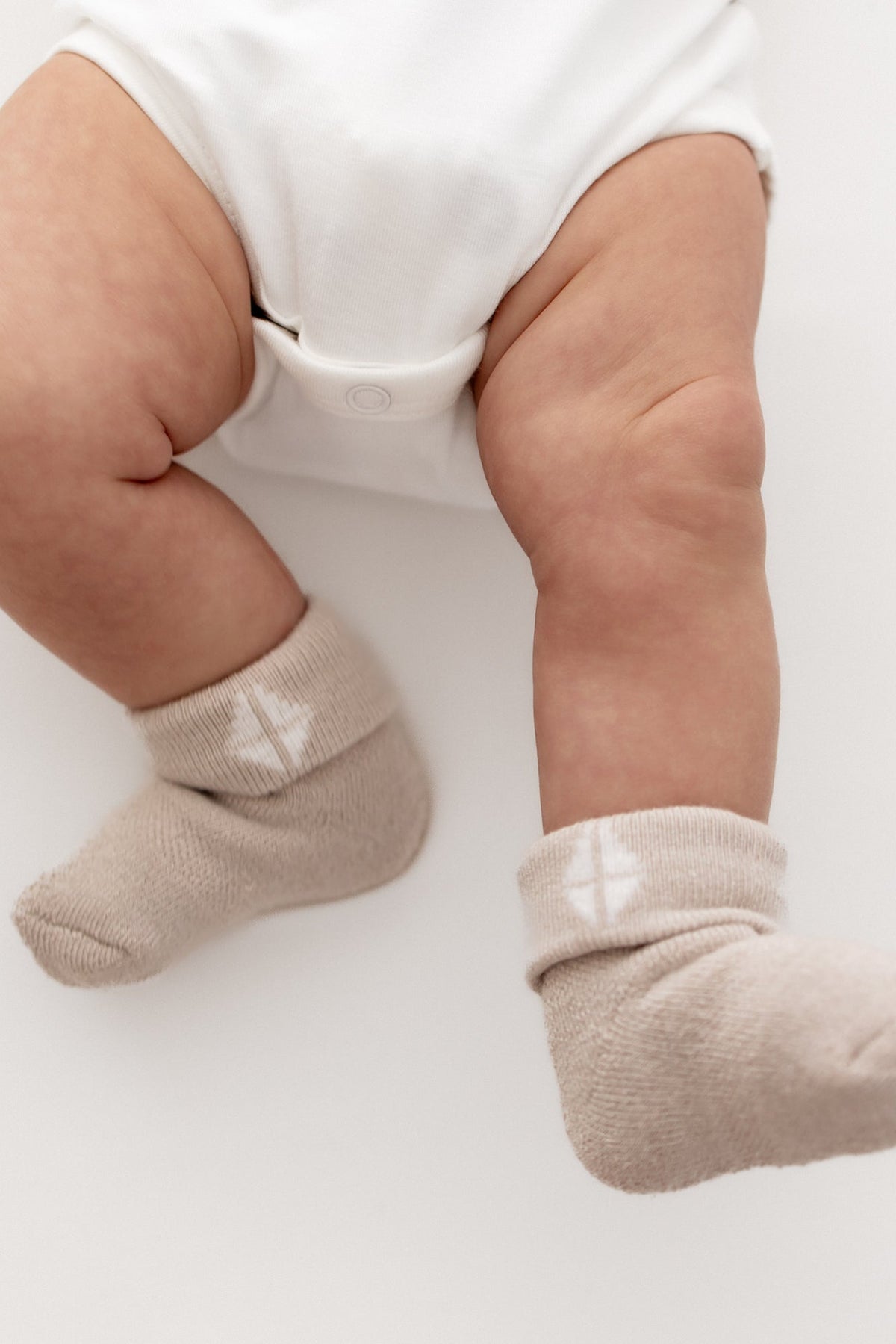 Baby wearing Oat tan infant socks