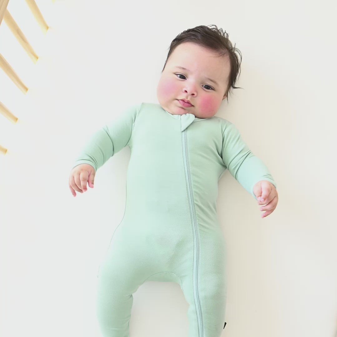 Video of a baby wearing the Zippered Footie in Sage