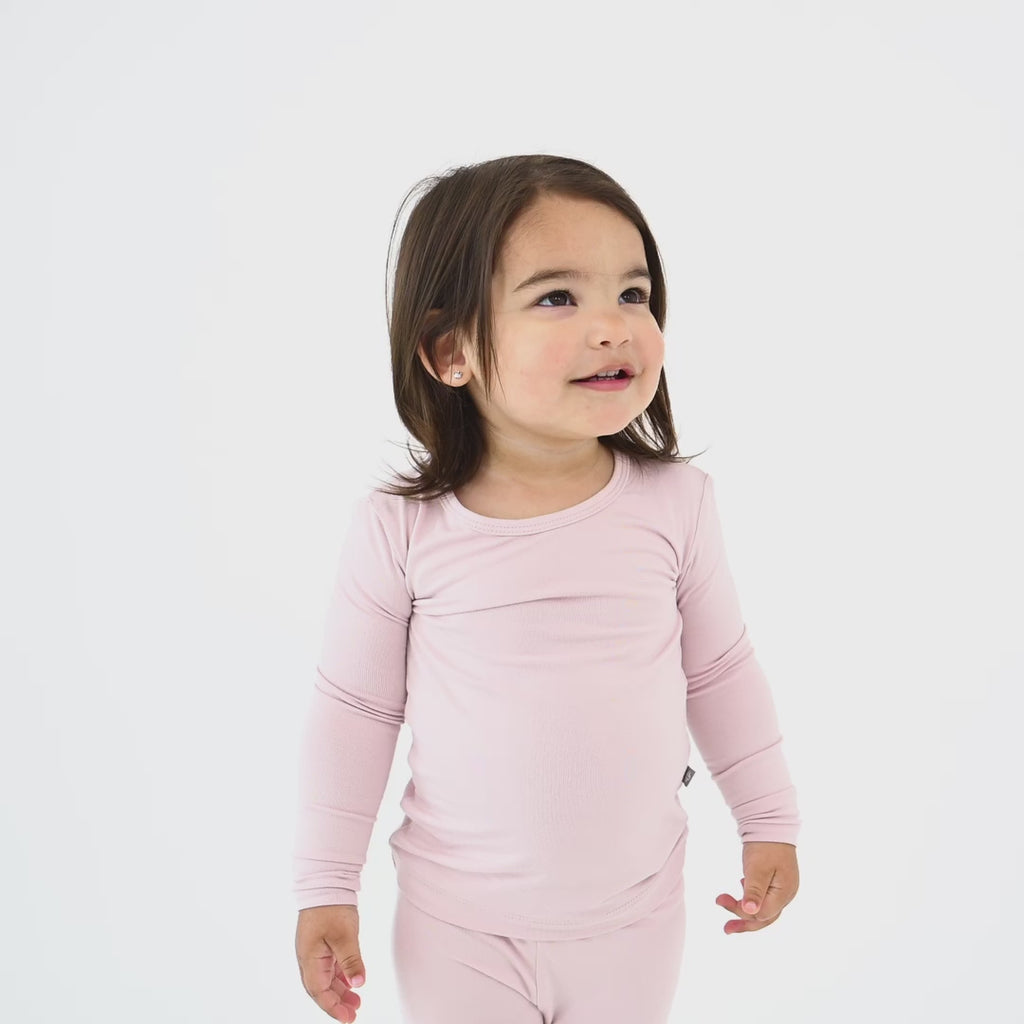 Video of Girl Wearing Long Sleeve Toddler Pajamas in Blush Pink