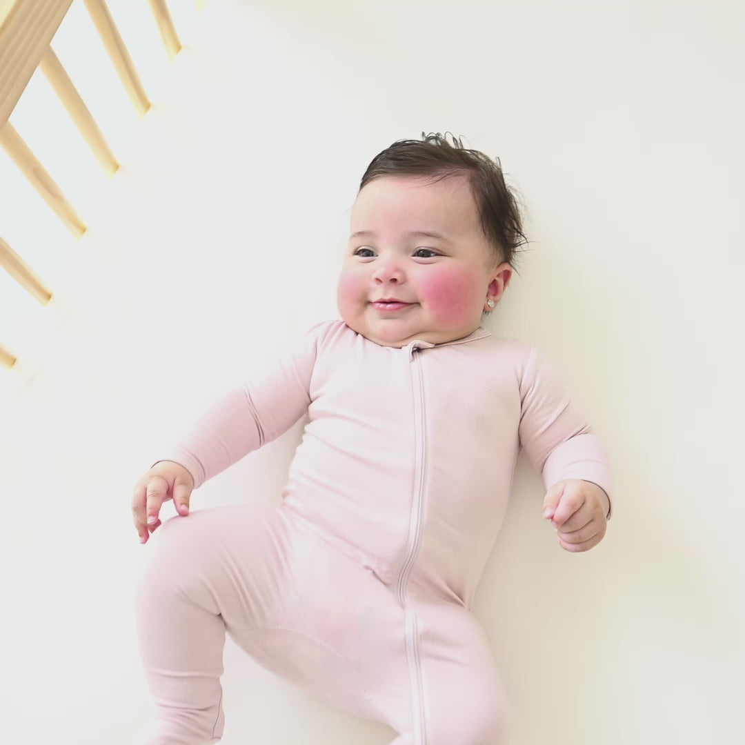 Video of an infant wearing the Zippered Footie in Blush
