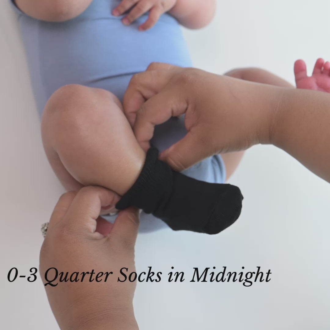 Video of Parent putting Quarter Socks in Midnight Black on baby