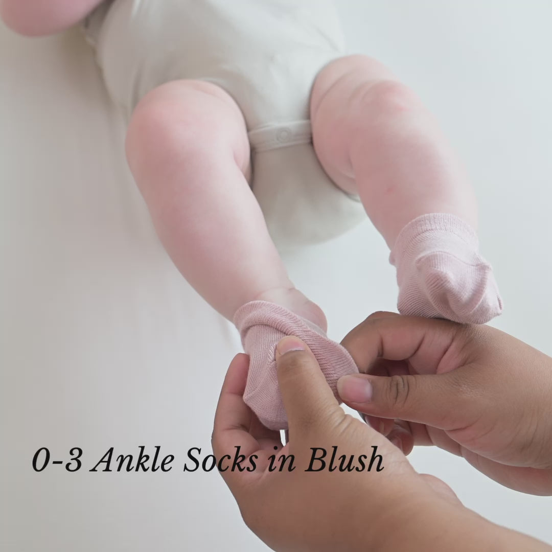 Video of parent putting ankle socks on newborn baby