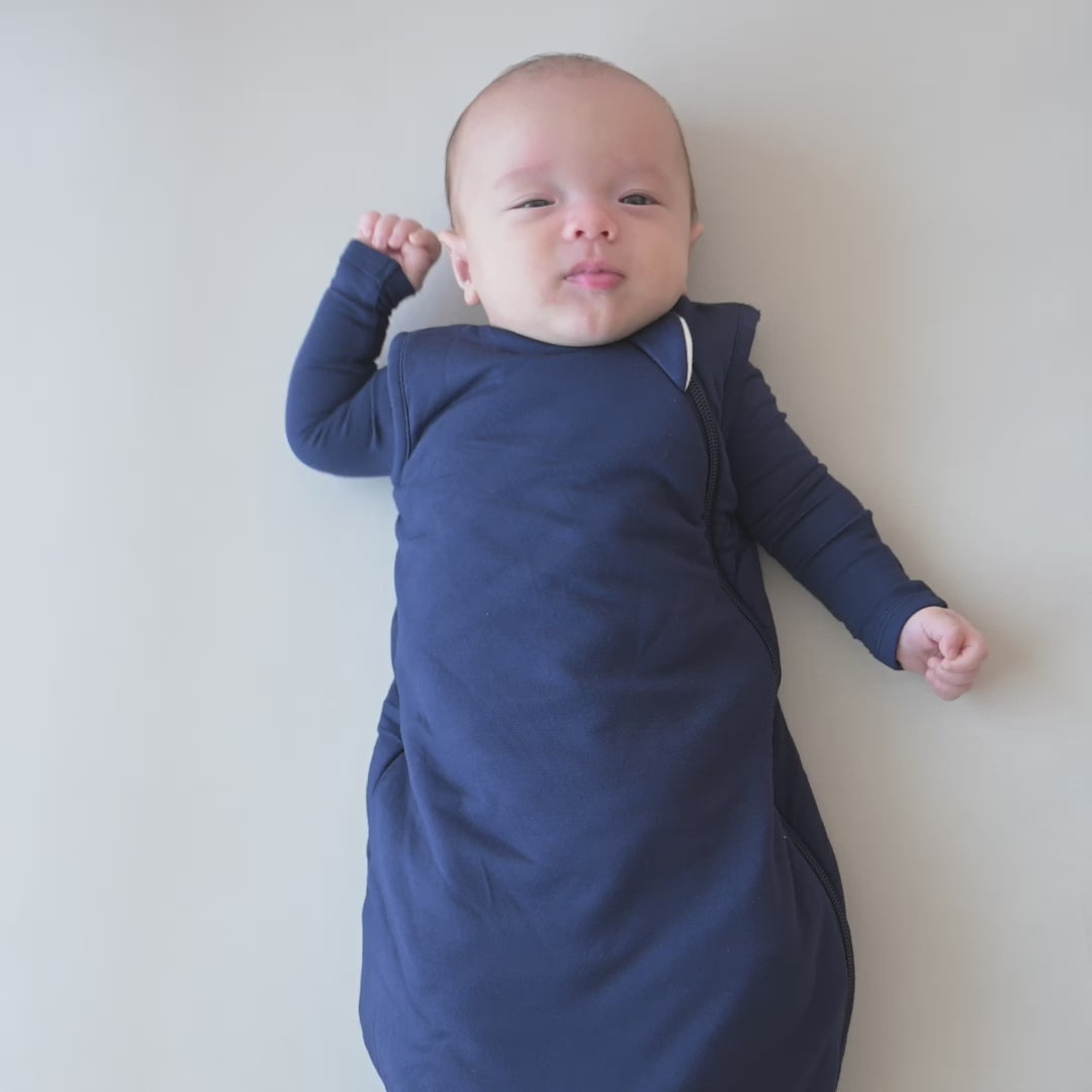 Video of a baby wearing the Sleep Bag in Navy 1.0