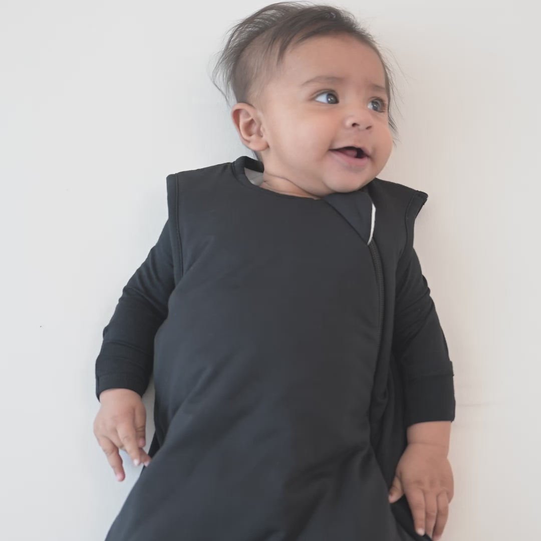Video of an infant model wearing the Sleep Bag in Midnight 1.0