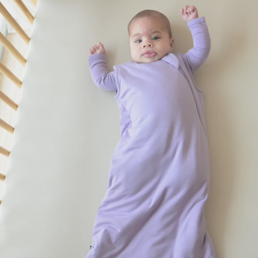 Video of a baby model wearing the 0.5 Tog Sleep Bag in Taro