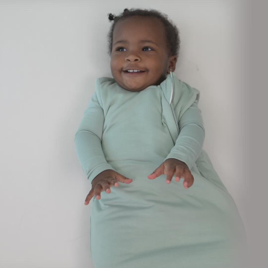 Video of an infant model wearing the Sleep Bag in Sage 1.0