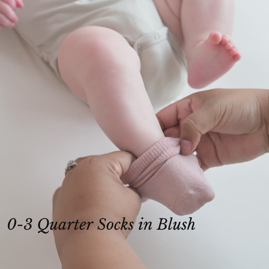 Video of parent putting Kyte Baby Blush Quarter Socks on Newborn