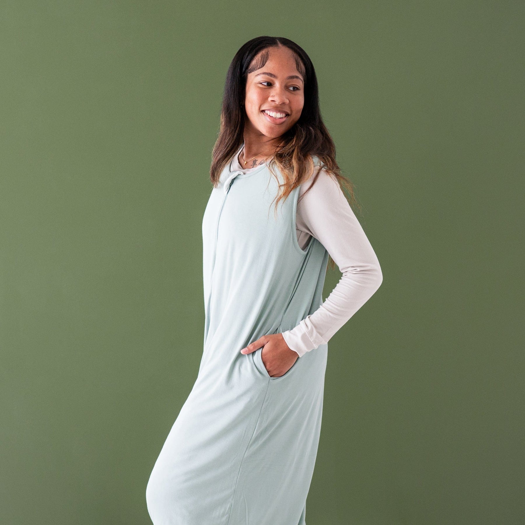 Woman wearing Kyte Baby bamboo Adult Sleep Bag Walker in Sage Green