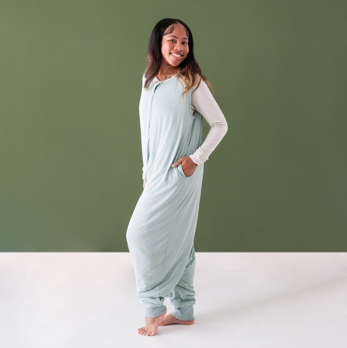 Woman wearing Kyte Baby Adult Sleep Bag Walker in Sage