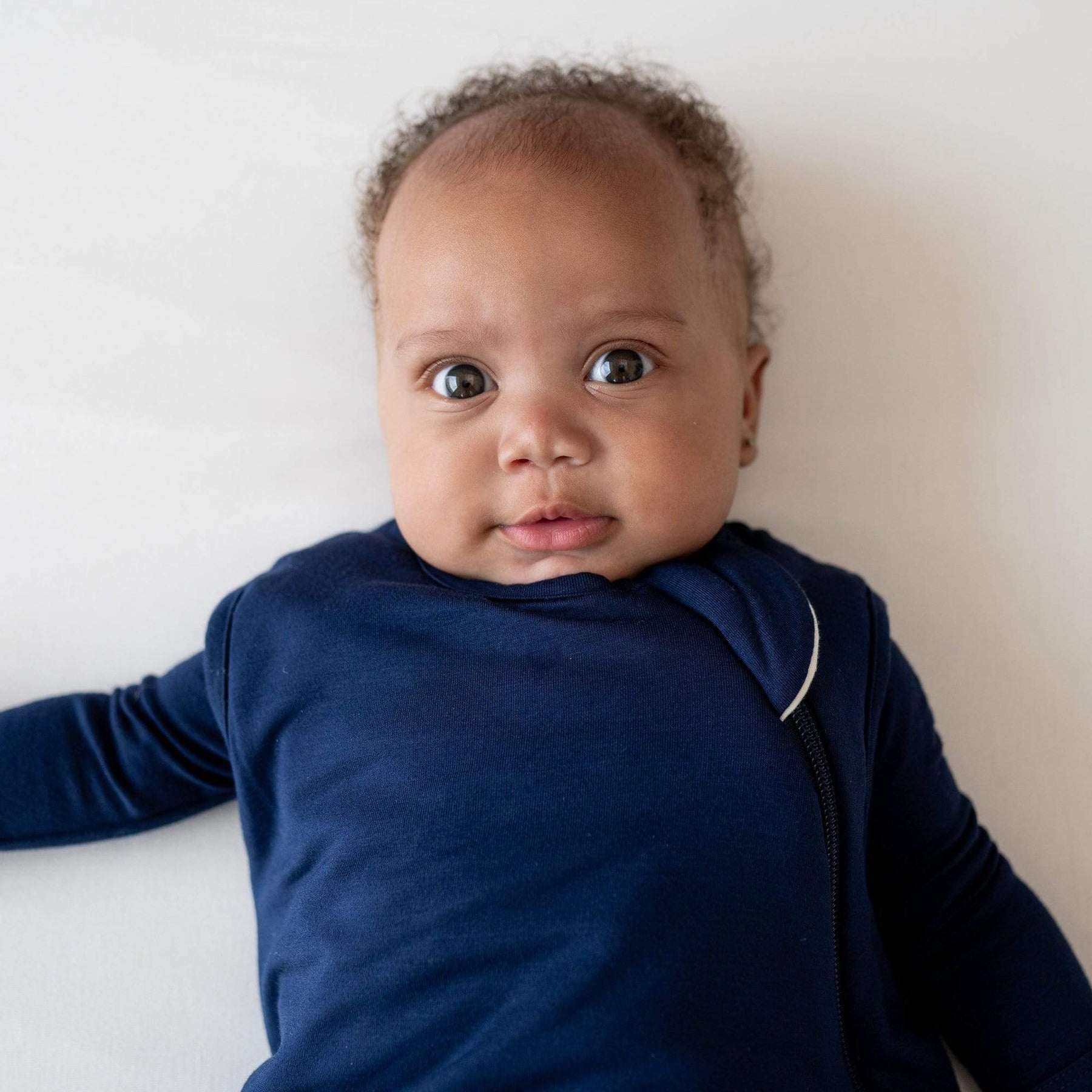 Close up of baby wearing Kyte Baby  Sleep Bag 1.0 in Navy