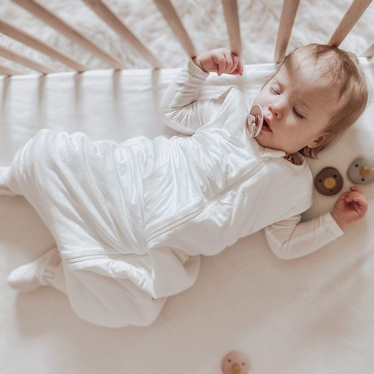 Sleeping Toddler wearing Kyte Baby Sleep Bag Walker in Cloud 2.5