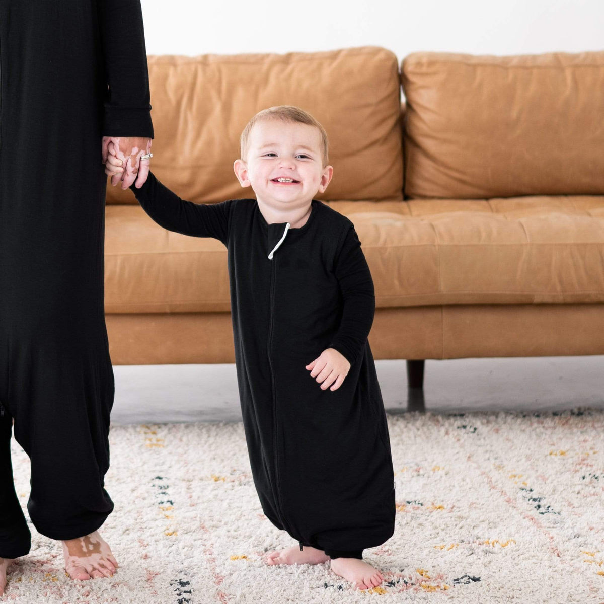 Mom and son in matching Kyte Baby Sleep Bag Walkers in Midnight 2.5