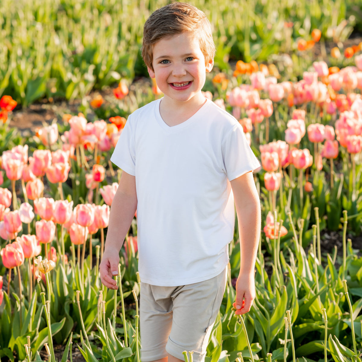 Boy wearing Kyte Baby short sleeve Toddler V-Neck Tee in Snow