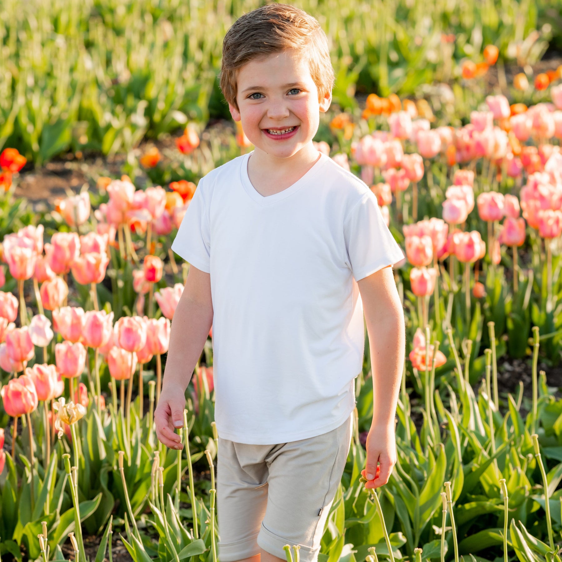 Boy wearing Kyte Baby short sleeve Toddler V-Neck Tee in Snow